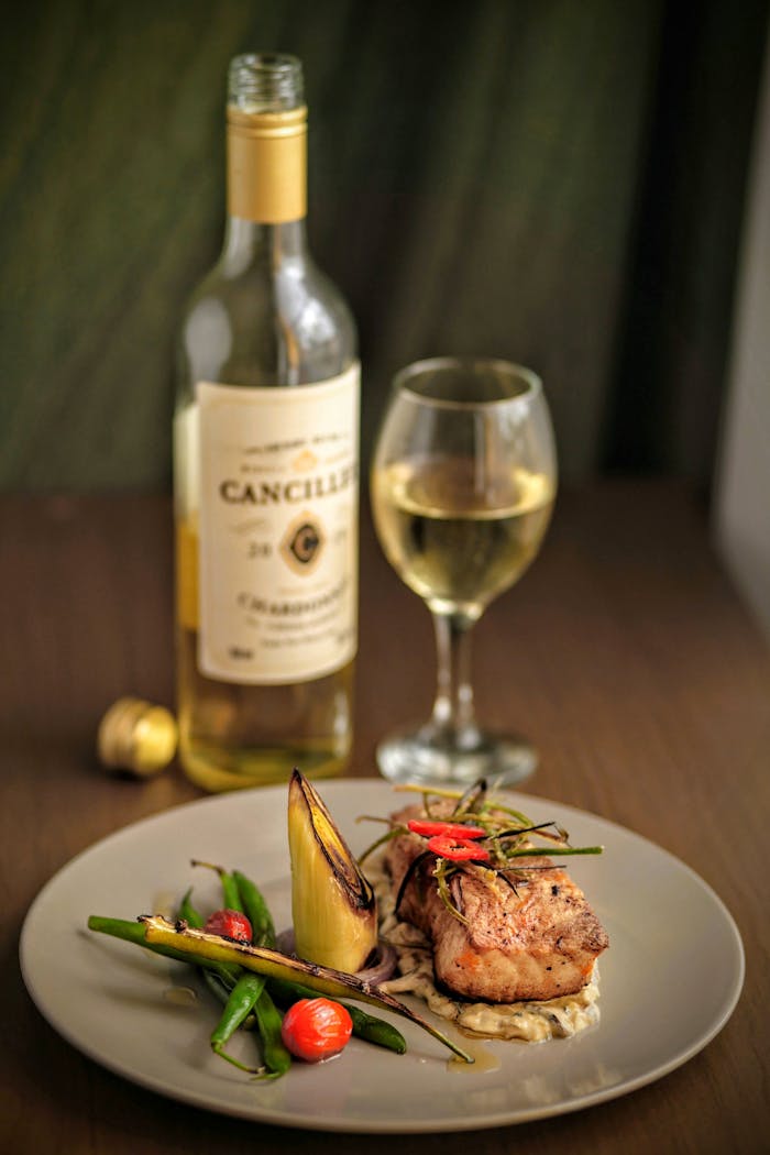 about-01 Savor a gourmet seafood dish paired with white wine in a Porto restaurant, showcasing fine dining in Portugal.