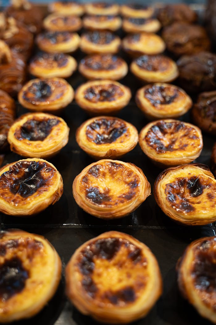 about-hero Mouth-watering Portuguese custard tarts in a Berlin bakery. Perfect sweet delight.