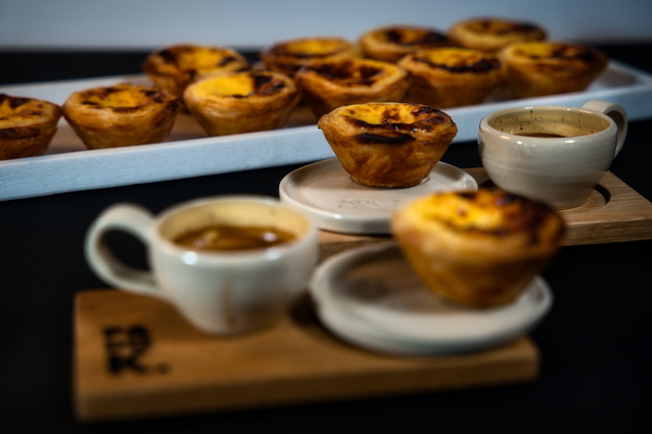 about-02 Close-up of traditional Pastel de Nata and espresso cups, perfect for a sweet treat in Berlin's cafes.